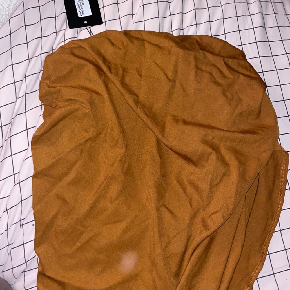 Brand new never worn has tags. Skirt is a high low skirt on the side.